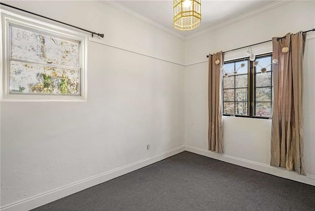 unfurnished room featuring baseboards, dark colored carpet, an inviting chandelier, and crown molding