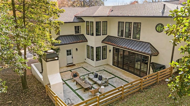 back of property with a shingled roof, a patio area, fence private yard, and stucco siding