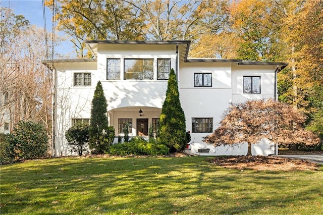 view of front of home featuring a front yard and stucco siding