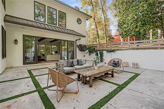 view of patio with fence and an outdoor living space