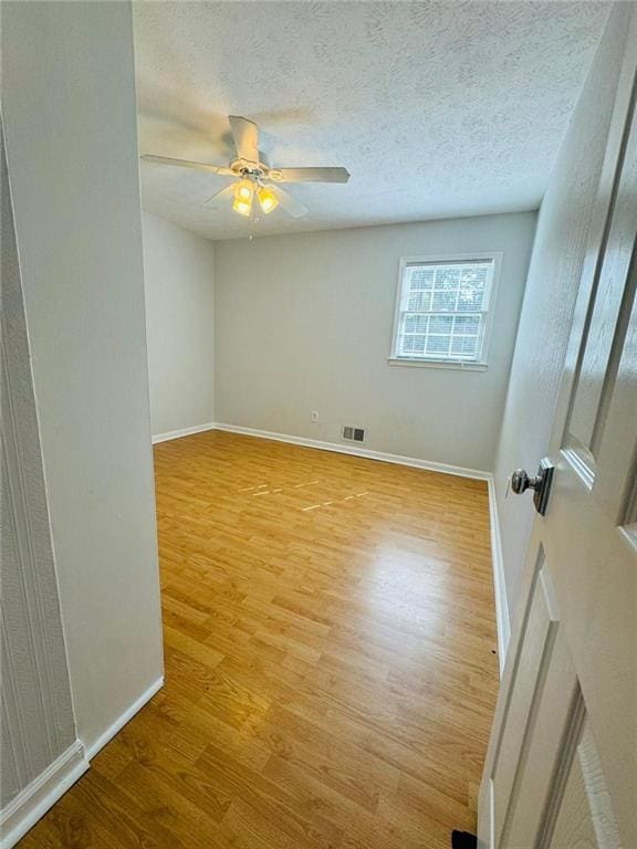 3210 Ebenezer Rd, Marietta, GA 30066 - unfurnished room featuring wood finished floors, baseboards, ceiling fan, and a textured ceiling