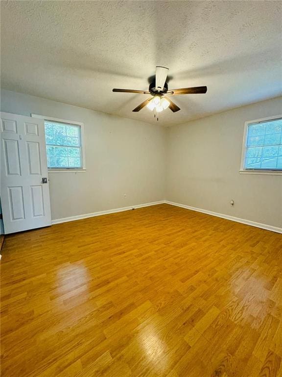 3210 Ebenezer Rd, Marietta, GA 30066 - unfurnished room with plenty of natural light, ceiling fan, light wood-type flooring, and a textured ceiling