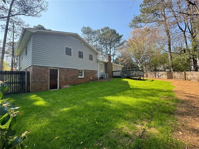 3210 Ebenezer Rd, Marietta, GA 30066 - rear view of house featuring brick siding, a wooden deck, and a chimney