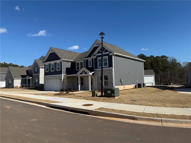 view of front of home featuring a garage and central AC