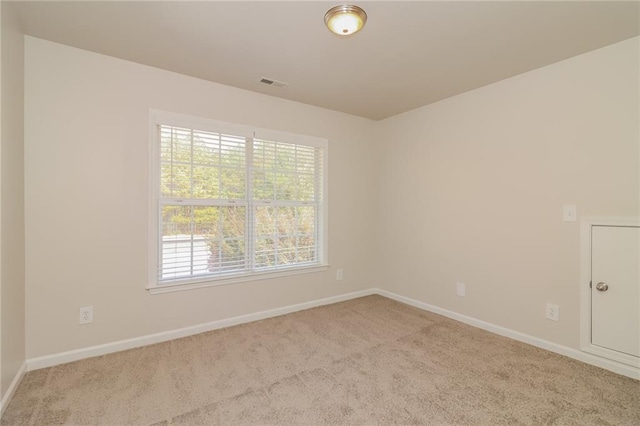 unfurnished room featuring light colored carpet