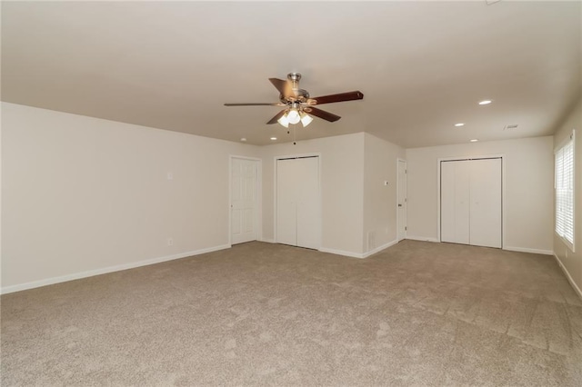 carpeted empty room featuring ceiling fan