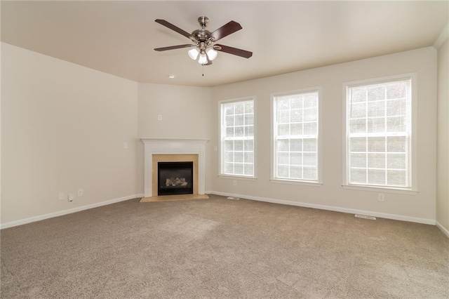 unfurnished living room featuring light colored carpet and ceiling fan