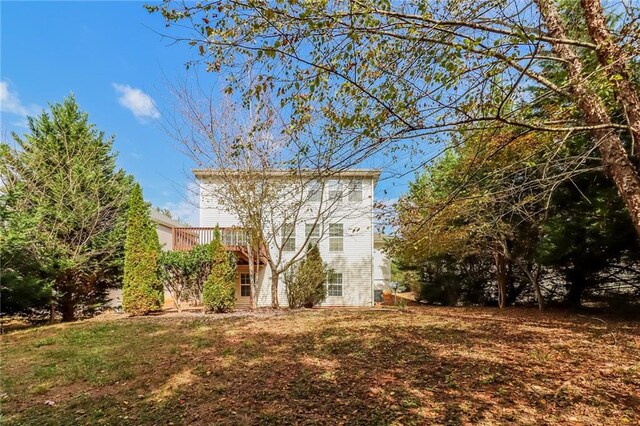 exterior space featuring a lawn and a deck