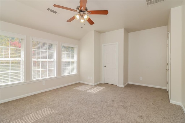 unfurnished bedroom featuring lofted ceiling, light carpet, and ceiling fan