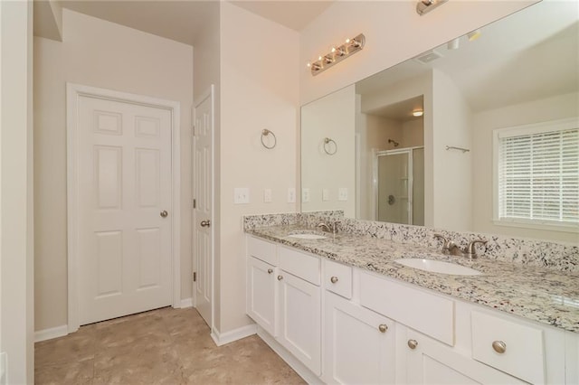 bathroom with vanity and a shower with door