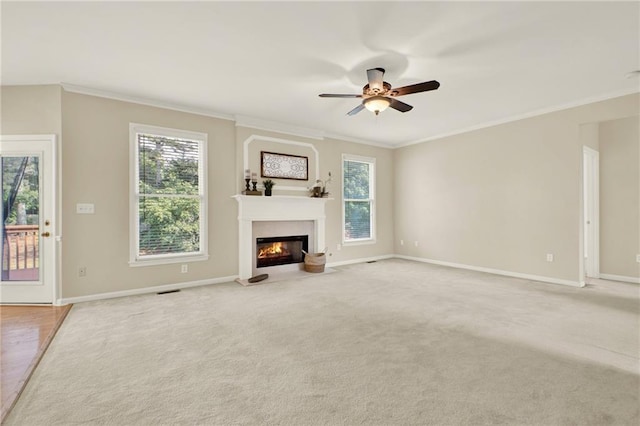4963 Kingsbridge Ct, Powder Springs, GA 30127 - unfurnished living room with crown molding, ceiling fan, healthy amount of natural light, a fireplace with flush hearth, and baseboards