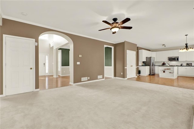4963 Kingsbridge Ct, Powder Springs, GA 30127 - unfurnished living room featuring arched walkways, light colored carpet, ceiling fan, baseboards, and ornamental molding