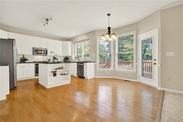4963 Kingsbridge Ct, Powder Springs, GA 30127 - kitchen with stainless steel appliances, dark countertops, light wood-style flooring, a chandelier, and white cabinets