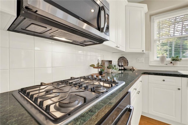4963 Kingsbridge Ct, Powder Springs, GA 30127 - kitchen featuring stainless steel appliances, white cabinetry, and tasteful backsplash