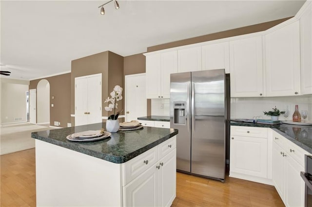 4963 Kingsbridge Ct, Powder Springs, GA 30127 - kitchen featuring stainless steel fridge, light wood finished floors, open floor plan, backsplash, and white cabinetry