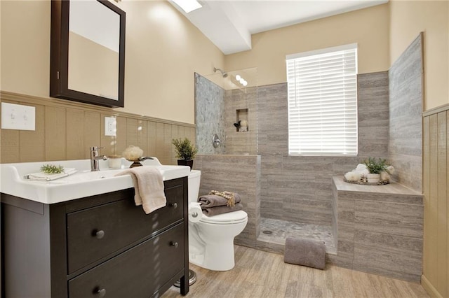 4963 Kingsbridge Ct, Powder Springs, GA 30127 - bathroom featuring toilet, a walk in shower, vanity, tile walls, and a wainscoted wall
