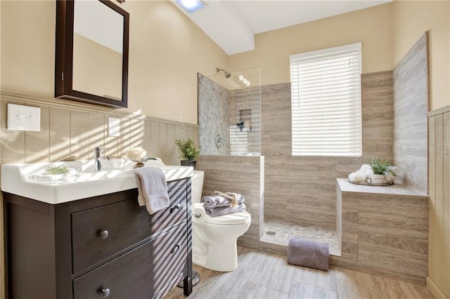4963 Kingsbridge Ct, Powder Springs, GA 30127 - bathroom with toilet, walk in shower, vanity, a wainscoted wall, and tile walls