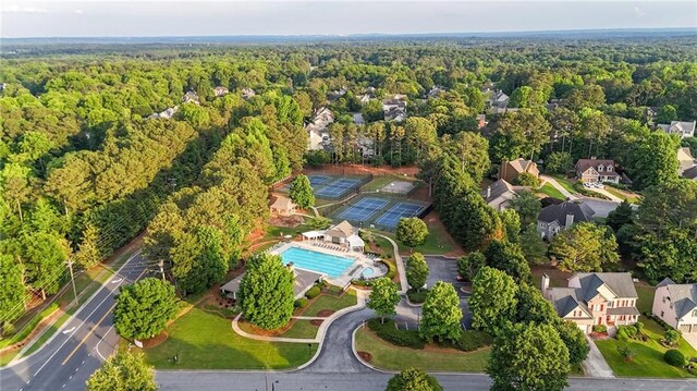 4963 Kingsbridge Ct, Powder Springs, GA 30127 - aerial view of property's location featuring a heavily wooded area, a pool, and nearby suburban area