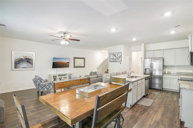 dining room featuring recessed lighting, dark wood-type flooring, ceiling fan, baseboards, and stairs