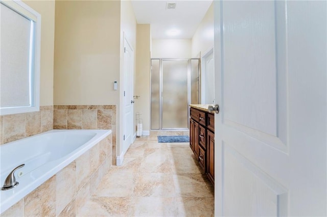 bathroom with a garden tub, a shower stall, and vanity