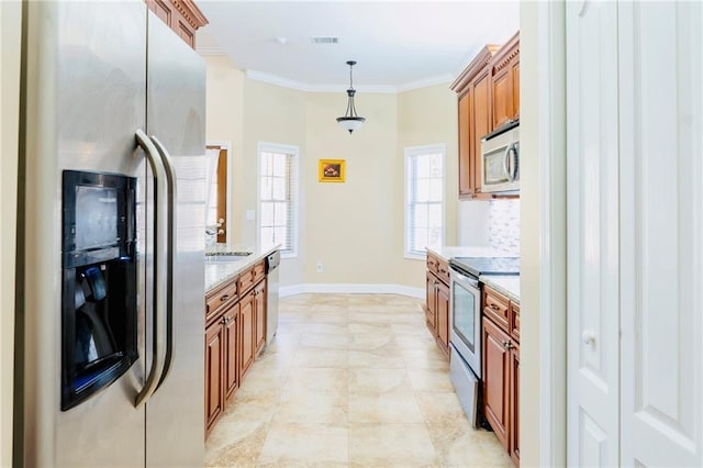 kitchen with stainless steel appliances, brown cabinetry, visible vents, and crown molding