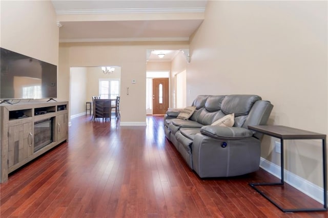 living room featuring a notable chandelier, baseboards, dark wood-style flooring, and ornamental molding