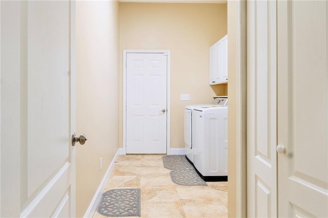 clothes washing area featuring cabinet space, independent washer and dryer, and baseboards