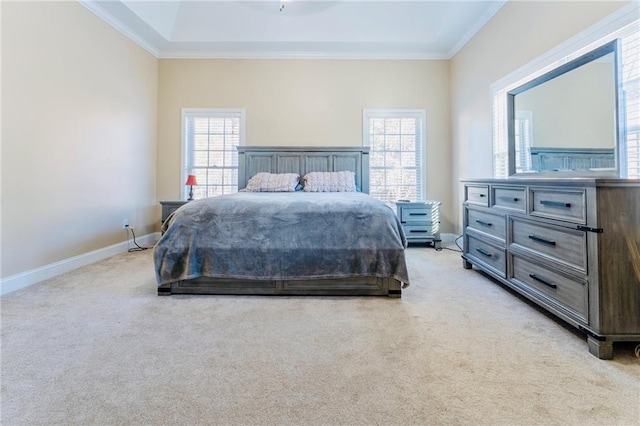 bedroom with ornamental molding, light colored carpet, and baseboards