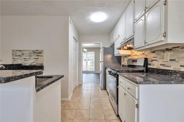 kitchen with stainless steel range with gas cooktop, white cabinets, backsplash, and a textured ceiling