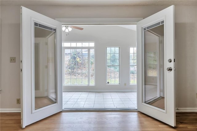 doorway to outside with light wood-type flooring and ceiling fan