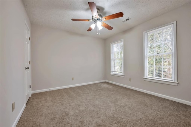 unfurnished room featuring carpet, a textured ceiling, and ceiling fan