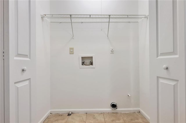 clothes washing area featuring gas dryer hookup, light tile patterned flooring, hookup for a washing machine, and electric dryer hookup