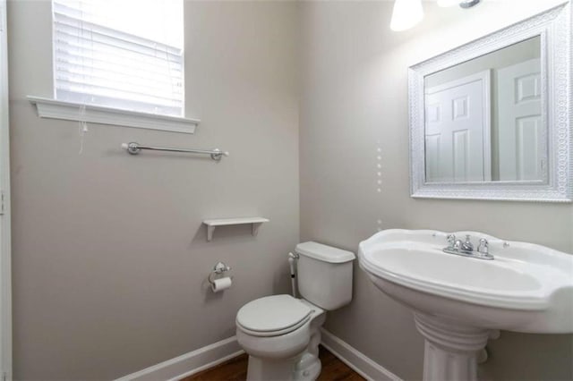 bathroom featuring hardwood / wood-style floors and toilet