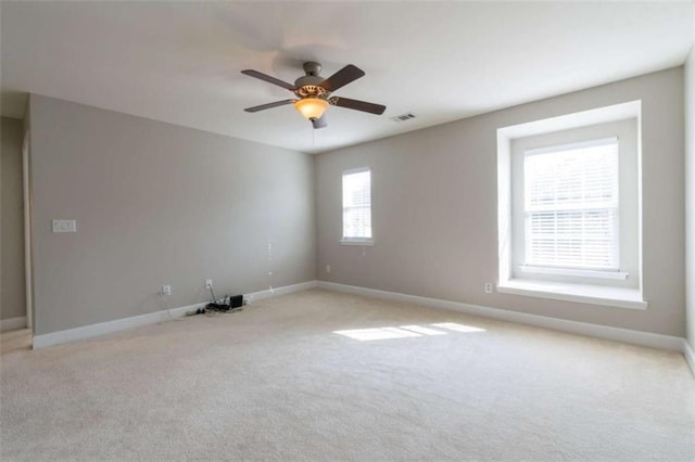 carpeted empty room featuring ceiling fan