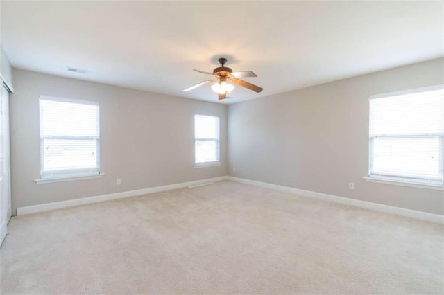 carpeted empty room featuring ceiling fan