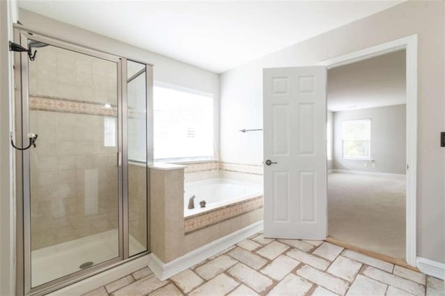 bathroom with shower with separate bathtub