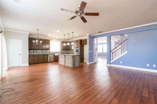 unfurnished living room with ornamental molding, dark hardwood / wood-style floors, and a healthy amount of sunlight