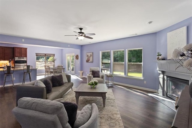 211 Parc Dr, Canton, GA 30114 - living room featuring dark wood-style floors, baseboards, ceiling fan, and a glass covered fireplace