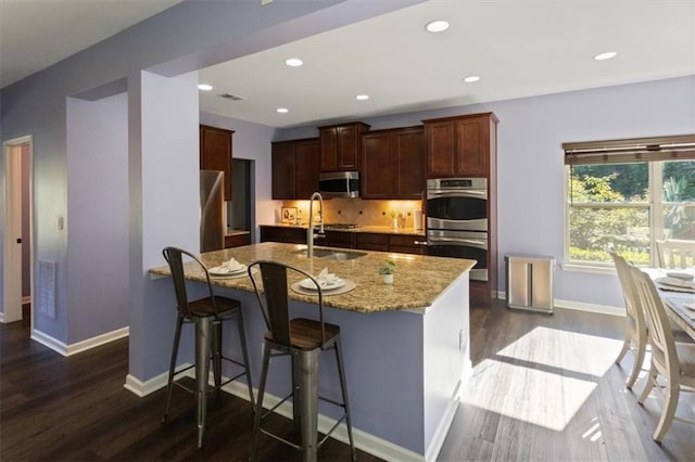 211 Parc Dr, Canton, GA 30114 - kitchen with stainless steel appliances, dark wood finished floors, light stone counters, baseboards, and recessed lighting