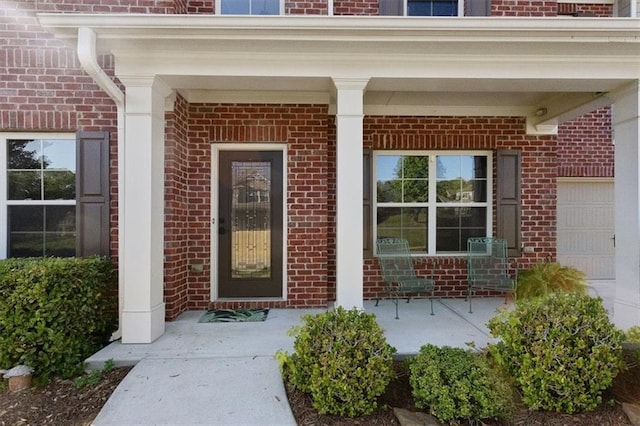211 Parc Dr, Canton, GA 30114 - doorway to property featuring brick siding and covered porch
