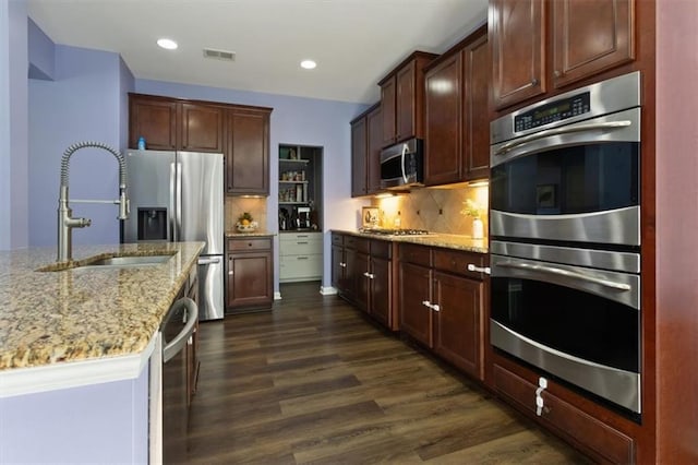 211 Parc Dr, Canton, GA 30114 - kitchen with stainless steel appliances, a sink, dark wood-type flooring, light stone counters, and recessed lighting