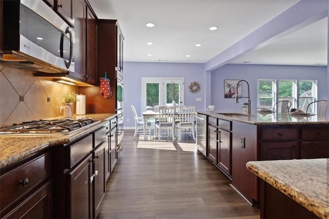 211 Parc Dr, Canton, GA 30114 - kitchen featuring appliances with stainless steel finishes, a sink, dark wood-style floors, light stone counters, and tasteful backsplash