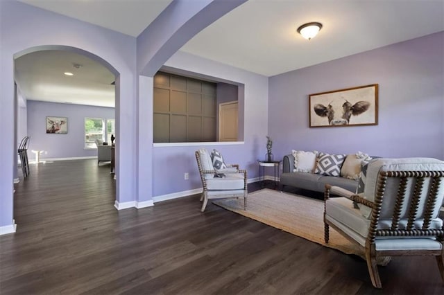 211 Parc Dr, Canton, GA 30114 - living room with dark wood-type flooring, baseboards, and arched walkways