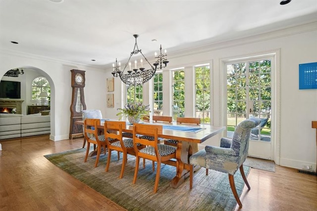 675 W Paces Ferry Rd NW Unit 11, Atlanta, GA 30327 - dining room with a notable chandelier, light wood-type flooring, baseboards, arched walkways, and ornamental molding