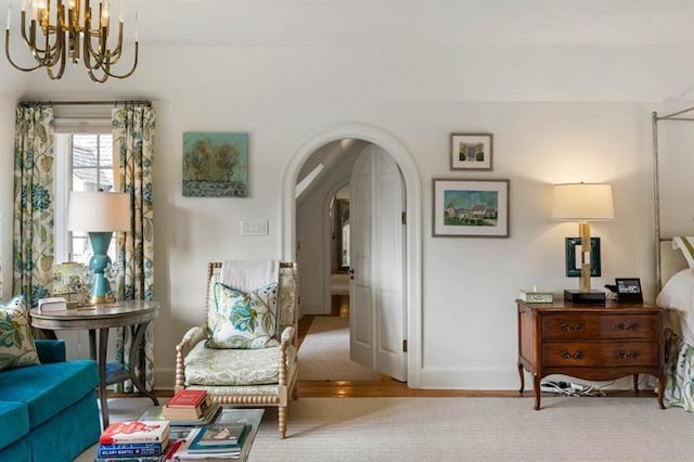 675 W Paces Ferry Rd NW Unit 11, Atlanta, GA 30327 - living area with a chandelier, arched walkways, baseboards, and wood finished floors