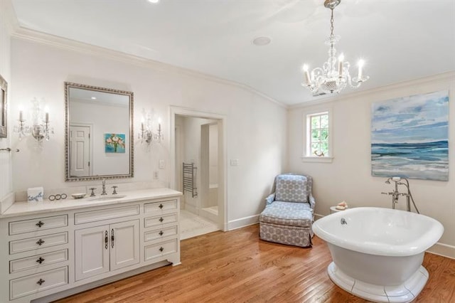 675 W Paces Ferry Rd NW Unit 11, Atlanta, GA 30327 - full bathroom with ornamental molding, an inviting chandelier, vanity, a freestanding bath, and wood finished floors
