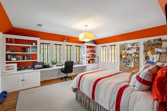 675 W Paces Ferry Rd NW Unit 11, Atlanta, GA 30327 - bedroom with visible vents, built in study area, and wood finished floors