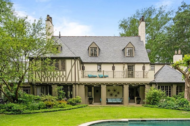 675 W Paces Ferry Rd NW Unit 11, Atlanta, GA 30327 - back of property with stucco siding, a chimney, a lawn, a balcony, and an outdoor pool