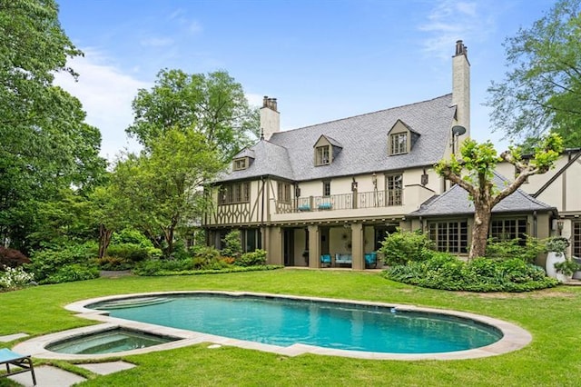675 W Paces Ferry Rd NW Unit 11, Atlanta, GA 30327 - back of property featuring a balcony, an in ground hot tub, a lawn, and an outdoor pool
