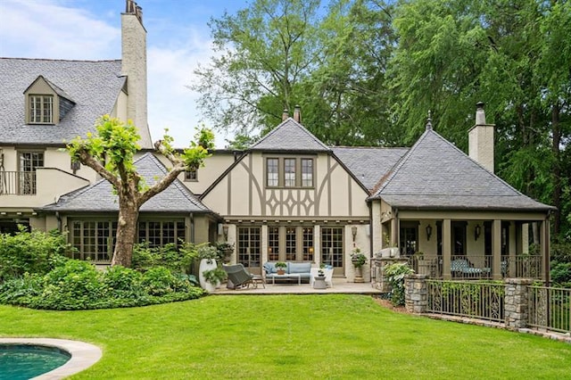 675 W Paces Ferry Rd NW Unit 11, Atlanta, GA 30327 - rear view of property featuring a yard, a patio, stucco siding, a chimney, and outdoor lounge area